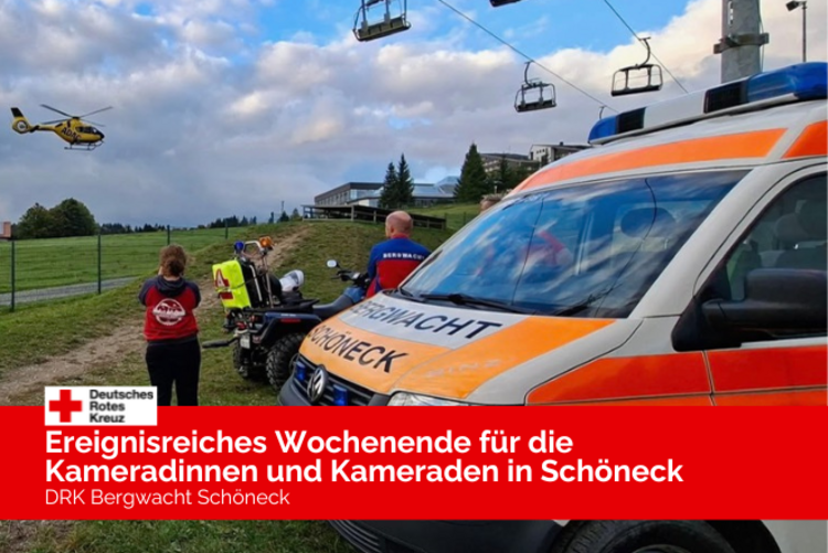 Der Krankentransportwagen der Bergwacht steht im Vordergrund, dahinter zwei Kameraden der Bergwacht, welche die Landung des Rettungshubschraubers Christoph 46 beobachten.